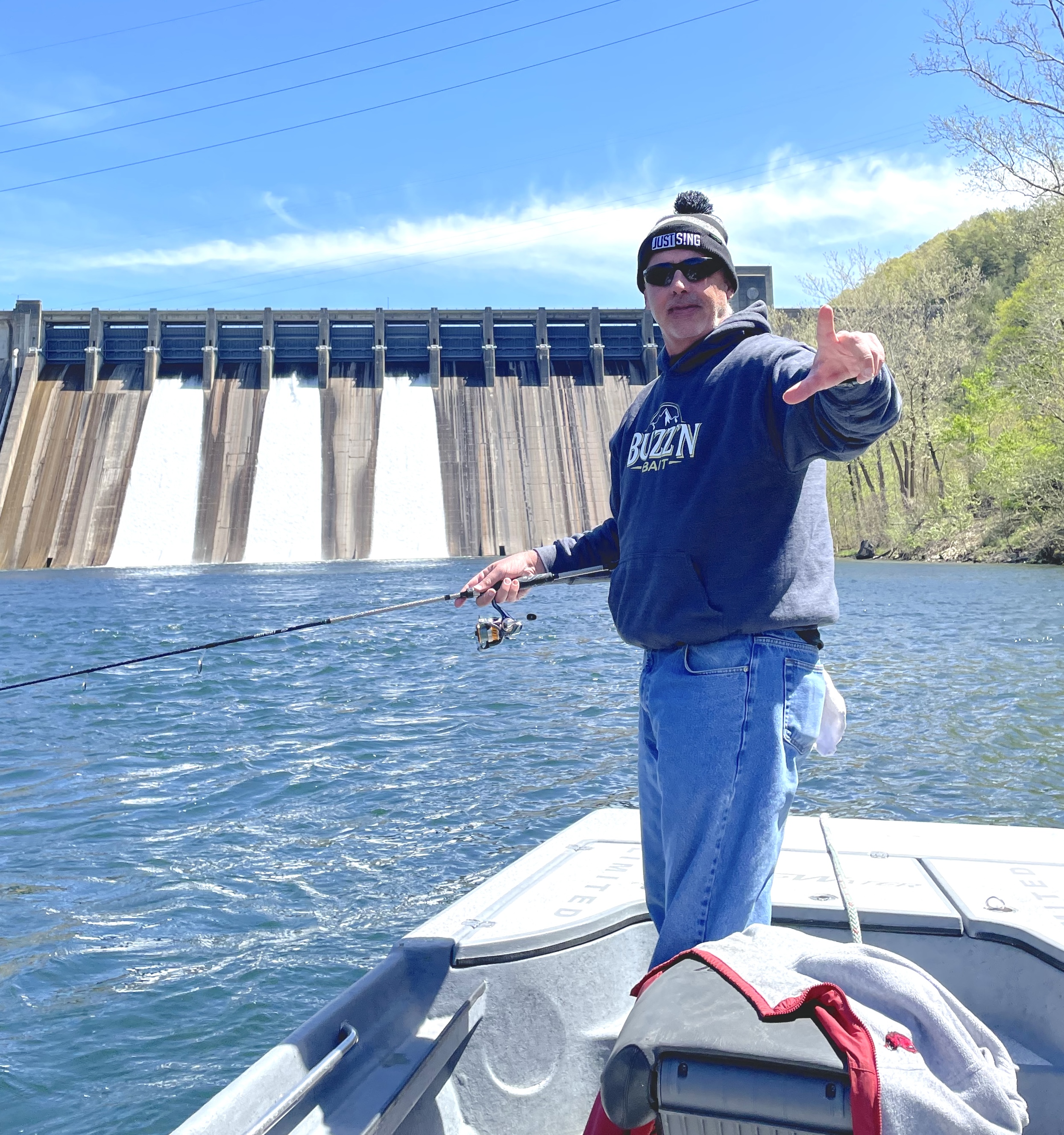 Bill Doshier fishing below Norfork Dam with the dam structure visible in the background
