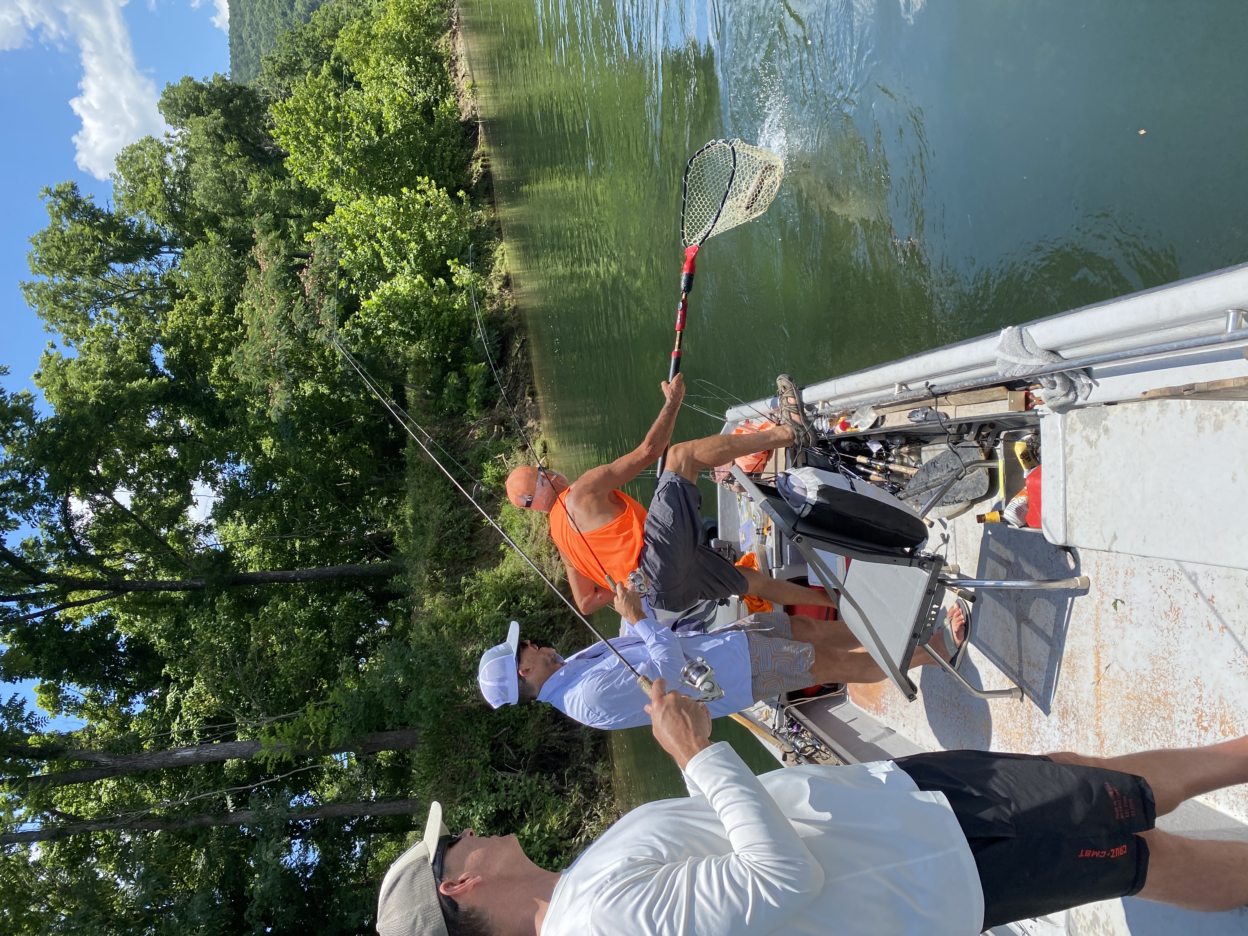 Netting a rainbow trout on the White River float, the boat on the move.